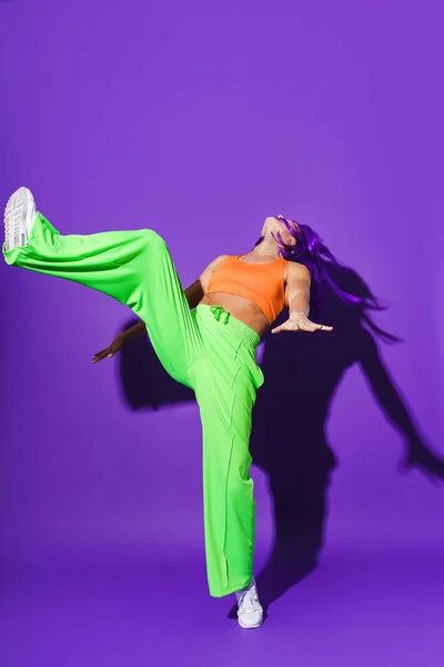 Carefree Active Woman Dancer Wearing Colorful Sportswear Performing Purple Background — Stock Photo, Image