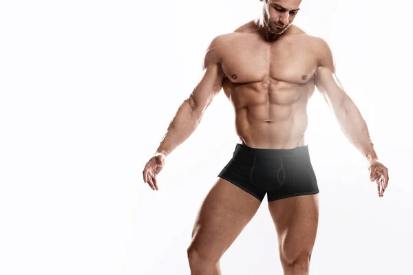 Muskulös Man Bodybuilder Bär Svarta Underkläder Poserar Mot Vit Bakgrund — Stockfoto