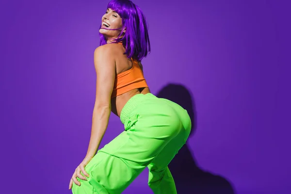 Carefree Woman Dancer Wearing Colorful Sportswear Twerking Purple Background — Stock Photo, Image
