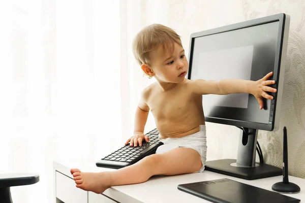 Little Boy Sitting Desk Playing Wireless Keyboard Widescreen Monitor Home — Stock Photo, Image