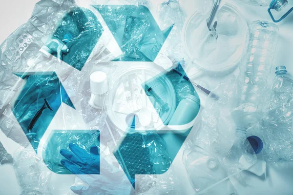 プラスチック廃棄物の山とリサイクルシンボルの背景 — ストック写真