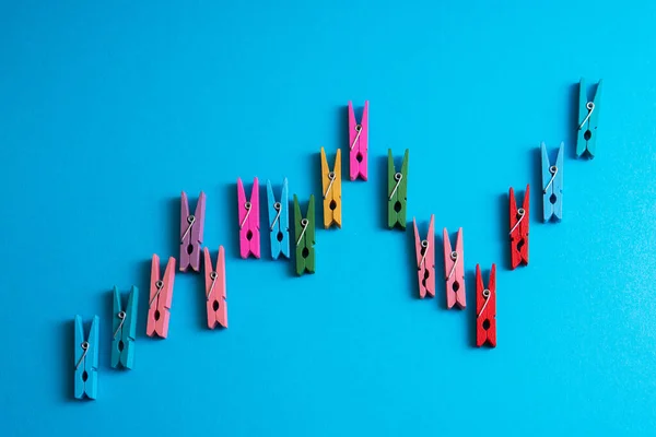Closeup Shot Financial Graph Made Colorful Wooden Clothespins Blue Background — Stock Photo, Image