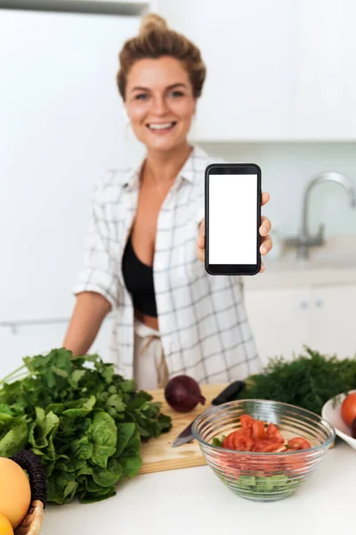 Young Cheerful Woman Holding Smartphone Blank Screen Your Design Cooking — Stock Photo, Image