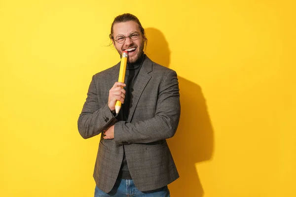 Cheerful Bearded Man Wearing Glasses Holding Big Penci Yellow Background — Stock Photo, Image