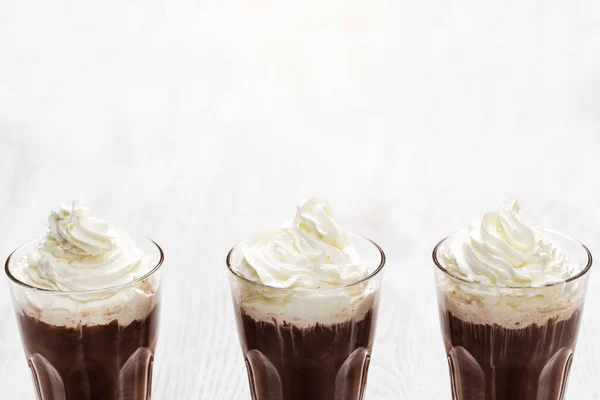 Glasses of delicious cold coffee with a whipped cream
