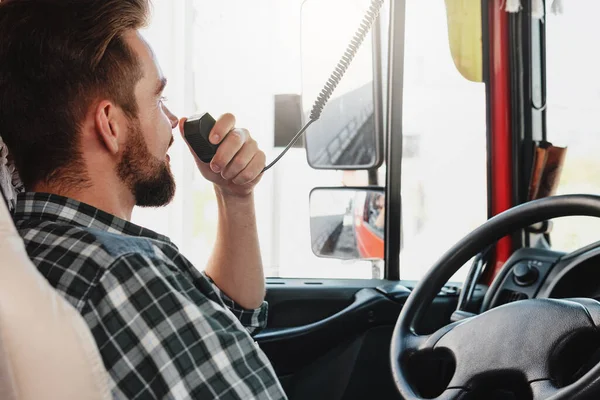 stock image Male truck driver talking by CB radio system in his vehicle