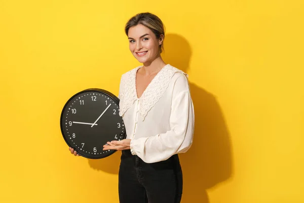 Cheerful Young Woman Holding Big Clock Yellow Background — Stock Photo, Image