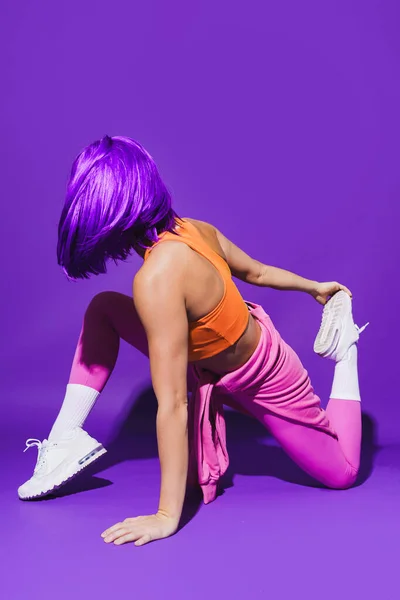 Young Woman Wearing Colorful Sportswear Stretching Workout Purple Background — Stock Photo, Image