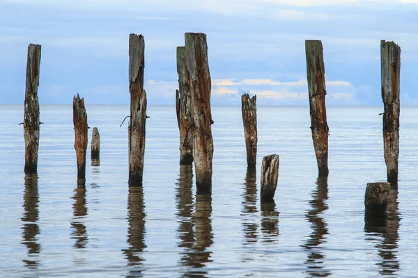 Beautiful Shot Calm Sea Scenery Broken Pier Poles Sticking Out Royalty Free Stock Images