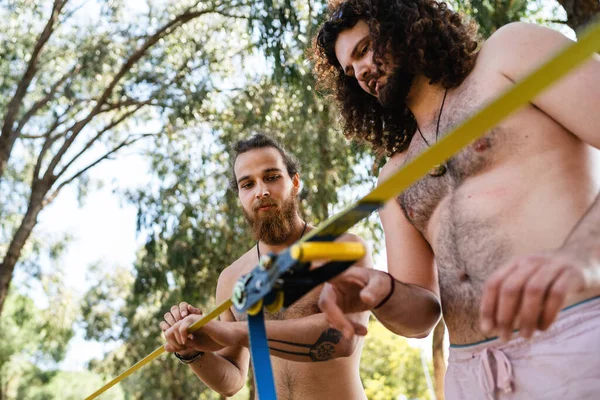 Two Young Men Setting Slacklining Equipment City Park Summer Day — Stock Photo, Image