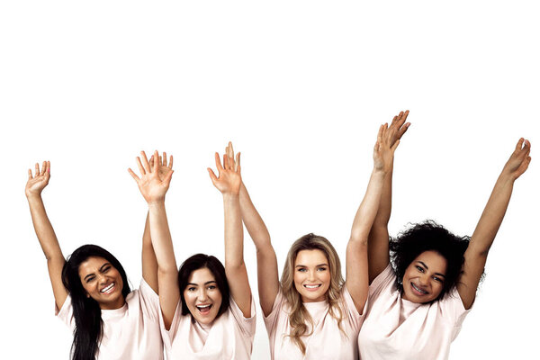 Multicultural diversity and friendship. Multi-ethnic group of  happy women raising hands against white background