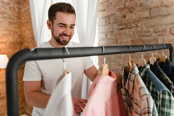 Young Man Browsing His Various Shirts Hanging Clothing Rack Wardrobe — Stock Photo, Image