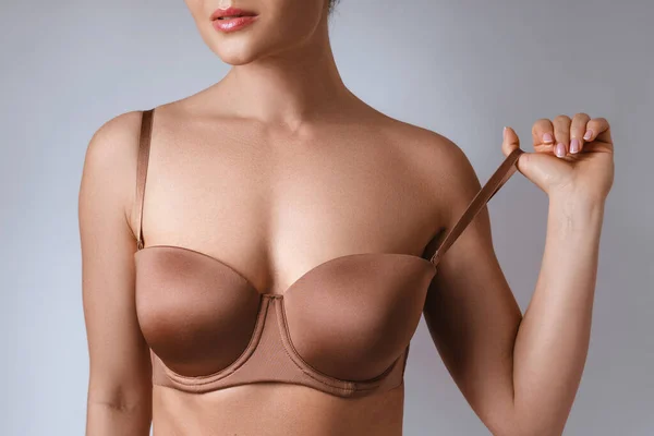 Closeup Female Breast Brown Bra Gray Background — Stock Photo, Image