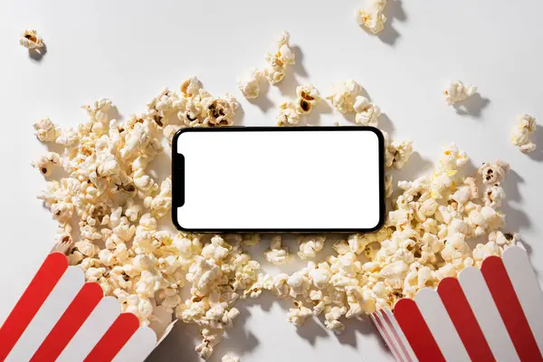 Classic popcorn buckets and smartphone with blank screen for your design.