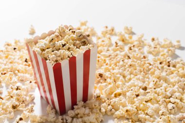 Beyaz arka planda lezzetli patlamış mısırlı klasik çizgili kova..