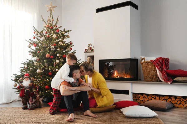Young Happy Family Sit Glowing Fireplace Cozy Living Room Adorned — Stock Photo, Image