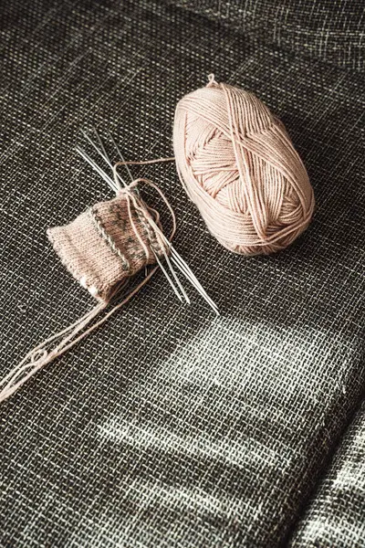 Closeup of woolen threads and knitting needles.