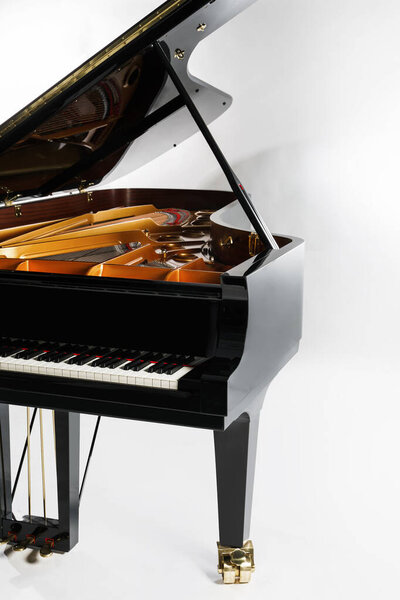 Luxury grand piano with open lid on gray background
