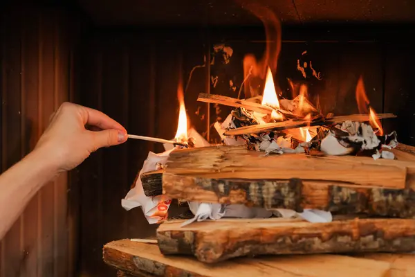 Female Hand Holds Matchstick Ready Ignite Firewood Fireplace — Stock Photo, Image