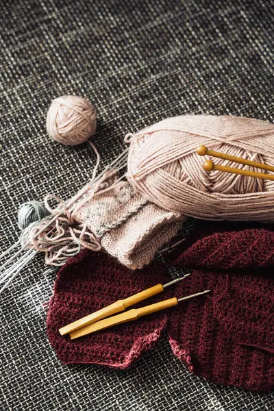 Closeup of woolen threads, knitting needles and crochet hooks