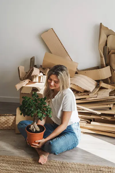 Mujer Joven Con Una Pequeña Planta Ficus Residuos Cartón Recogidos Imagen de stock