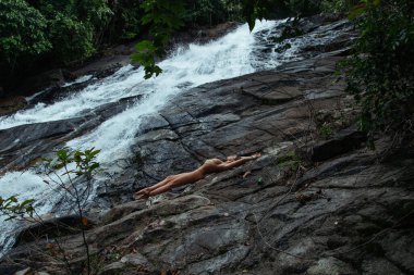 Şelale yakınlarında poz veren Güzel Çıplak Kadın.