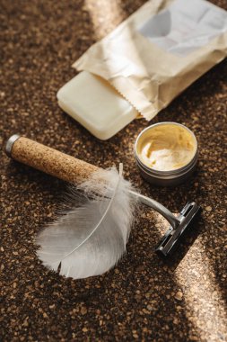 Safety Razor with Cork Handle, Shaving Soap, and Balm on Cork Surface. clipart