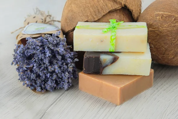Handmade natural cosmetics products. Soaps with natural ingredients on wooden background. Holistic cosmetics.