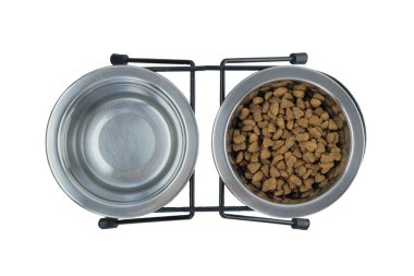 Dry food and water for cat or dog in metal bowls isolated on a white background. Cat food.Top view.