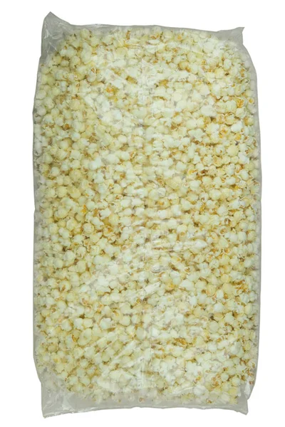 一大包爆米花装在一个透明的袋子里 与白色背景隔离 顶部视图 — 图库照片