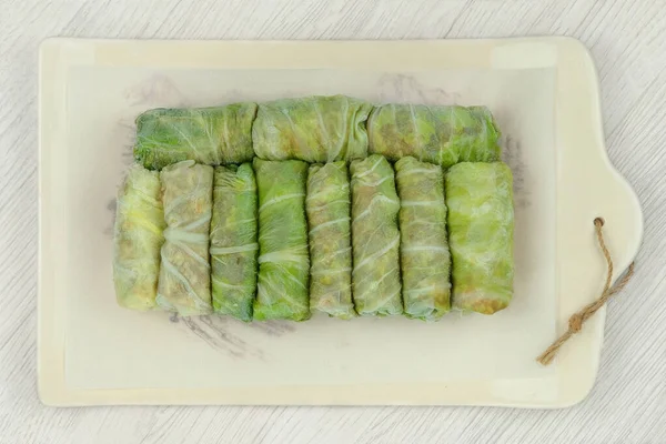 stock image Frozen doves on a ceramic tray. Stuffed cabbage rolls are frozen. Top view.