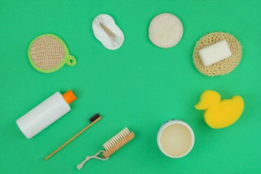 Çamaşır bezleri, şampuan, sabun ve yeşil arka planda hijyen için diğer aksesuarlar. Temiz ve hijyen kavramı. Uzayı kopyala Üst görünüm.