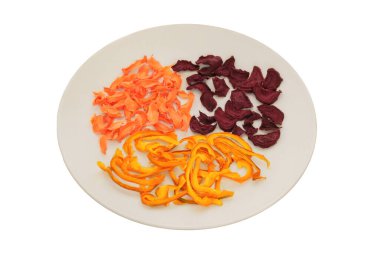 Beyaz arka planda izole edilmiş seramik tabakta kurutulmuş pancar, tatlı biber ve havuç. Çeşitli sebzeler. Dondurulmuş öğle yemeği hazırlamak için..