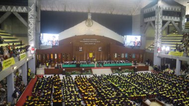 Depok, Indonesia - March 1, 2024: Bachelor and diploma graduation at the University of Indonesia Hall. clipart