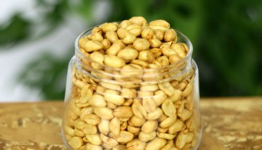 Fried peanuts in a jar. clipart