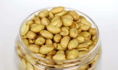 Fried peanuts in a jar. clipart