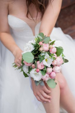 wedding delicate bouquet in the hands of the bride in a white dress. idea for event agencie