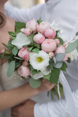 wedding delicate bouquet of flowers in the hands of the bride and groom on a holiday. concept idea for event agencie