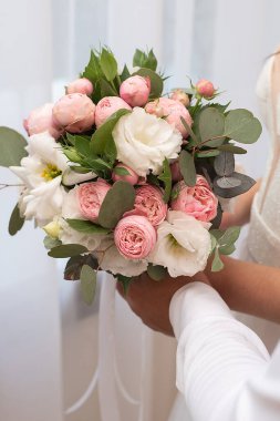 wedding delicate bouquet in the hands of the bride in a white dress. idea for event agencie