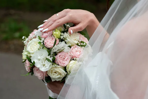 wedding delicate bouquet in the hands of the bride in a white dress. idea for event agencie