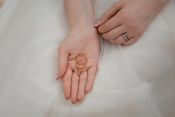 bride holds wedding rings in her hand. concept for event agencies