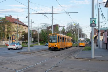 BUDAPEST, HUNGARY - 26 Nisan 2022. Trams Duewag TW6000 # 1543 (eski. Hannover # 6041) ve Ganz KCSV7 # 1348 Budapeşte sokaklarında yolcularla at sürüyor.