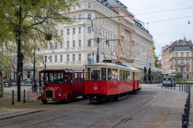 BRATISLAVA, SLOVAKIA - April 24, 2022. Trams DPMB #38 and CGP-DPMB #135 riding with passengers in the streets of Bratislava.