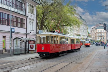 BRATISLAVA, SLOVAKIA - April 24, 2022. Trams DPMB #38, CGP-DPMB #135, Tatra T3M #7733 and 7734 riding with passengers in the streets of Bratislava.