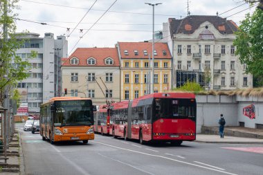 BRATISLAVA, SLOVAKIA - April 26, 2022. Buses Irisbus Citelis 12M #1032 and Solaris Urbino 18 #3222 riding with passengers in the streets of Bratislava.