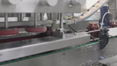 Bal dolgulu cam kavanozlar fabrika üretim hattında ustalıkla paketlenir..