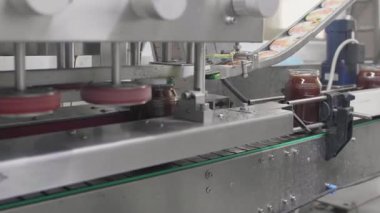 Bal dolgulu cam kavanozlar fabrika üretim hattında ustalıkla paketlenir..