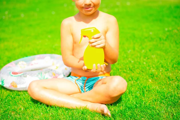 Cute Smiling Boy Sits Green Grass Swimming Trunks Holds Safe — Photo