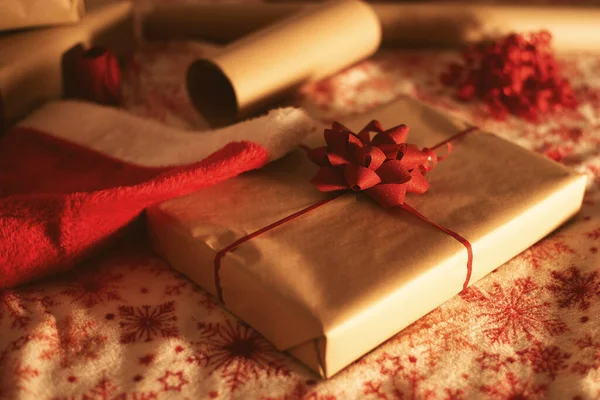 Gift wrapping kit kraft paper, red ribbon, gift box and red santa hat
