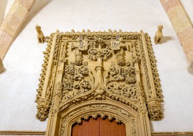 Ancient Templar church interior in Segovia, Spain. The nave features towering stone columns and imposing Romanesque arches, highlighting the simple, solemn architecture.
